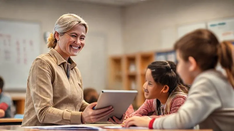 photorealistic, professional photography, 8K, cinematic lighting, sharp focus, depth of field, shot on a high-end DSLR. A dedicated, professional teacher smiling confidently while interacting with students in a modern classroom. The teacher is using a tablet or interactive whiteboard, and the students are engaged with digital learning tools, illustrating seamless integration of EdTech into daily teaching practice. Soft, warm lighting. photorealistic, professional photography, 8K, cinematic lighting, sharp focus, depth of field, shot on a high-end DSLR. A dedicated, professional teacher smiling confidently while interacting with students in a modern classroom. The teacher is using a tablet or interactive whiteboard, and the students are engaged with digital learning tools, illustrating seamless integration of EdTech into daily teaching practice. Soft, warm lighting.